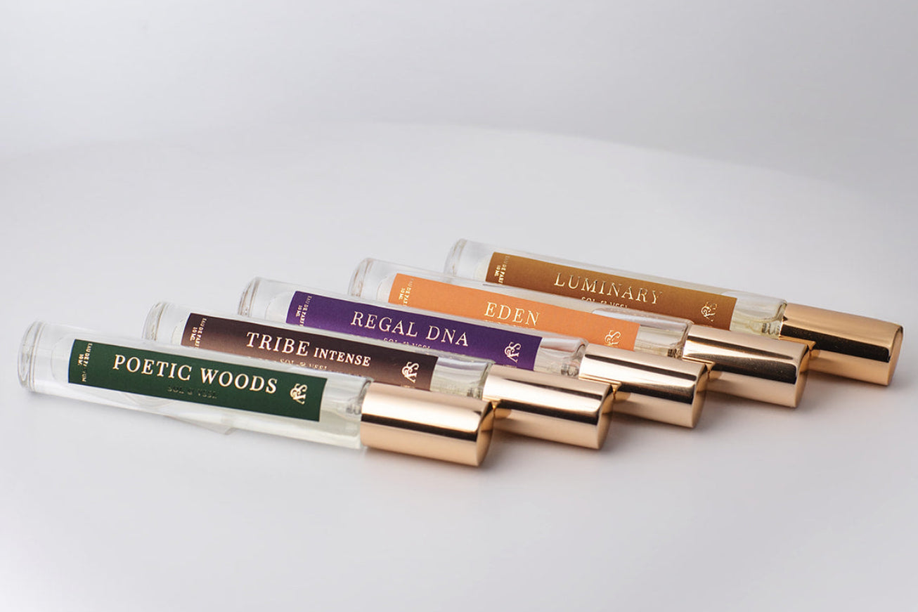 Set of small perfume bottles with colorful labels on a light gray background