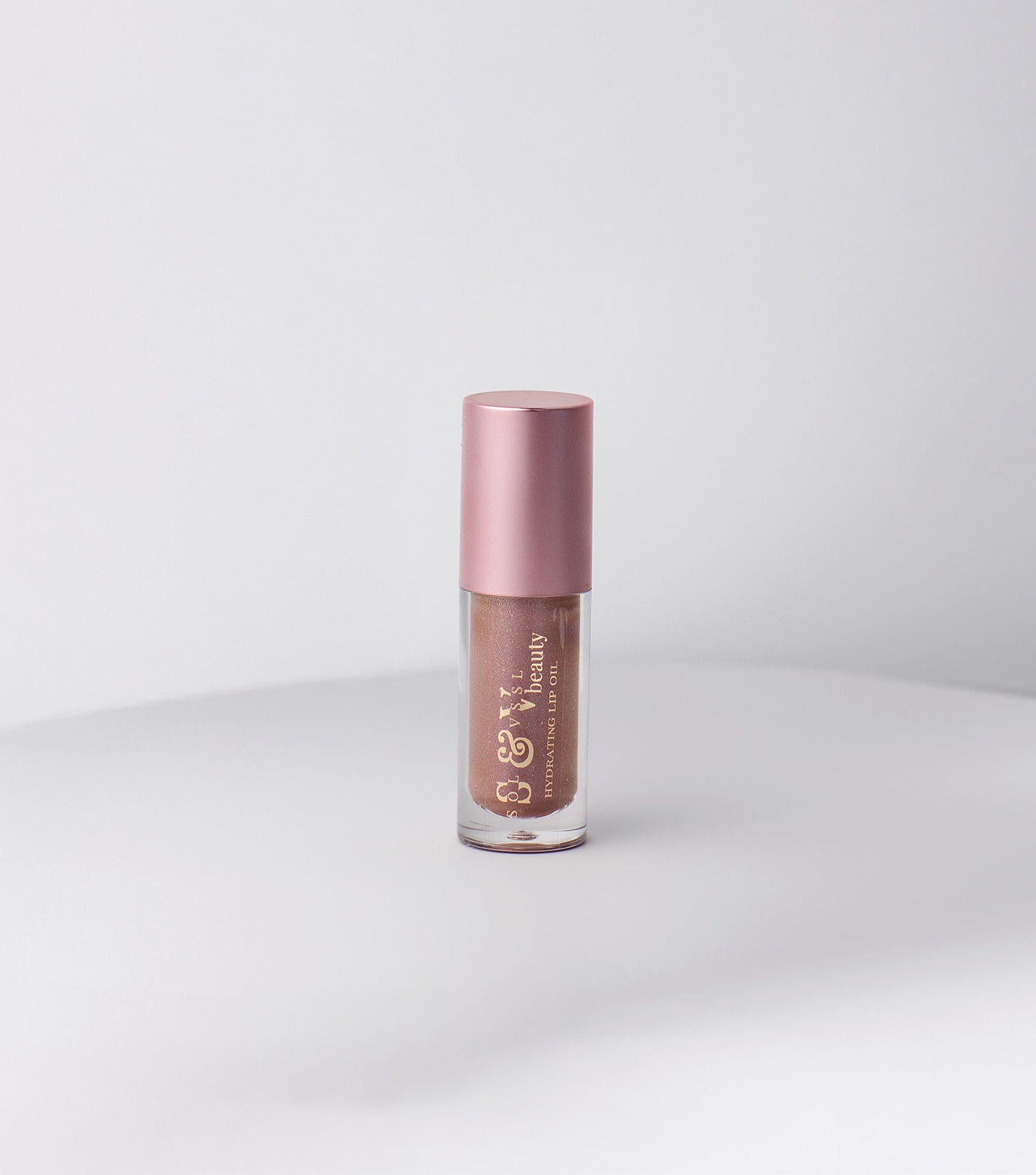 Lip gloss with pink cap on a white background