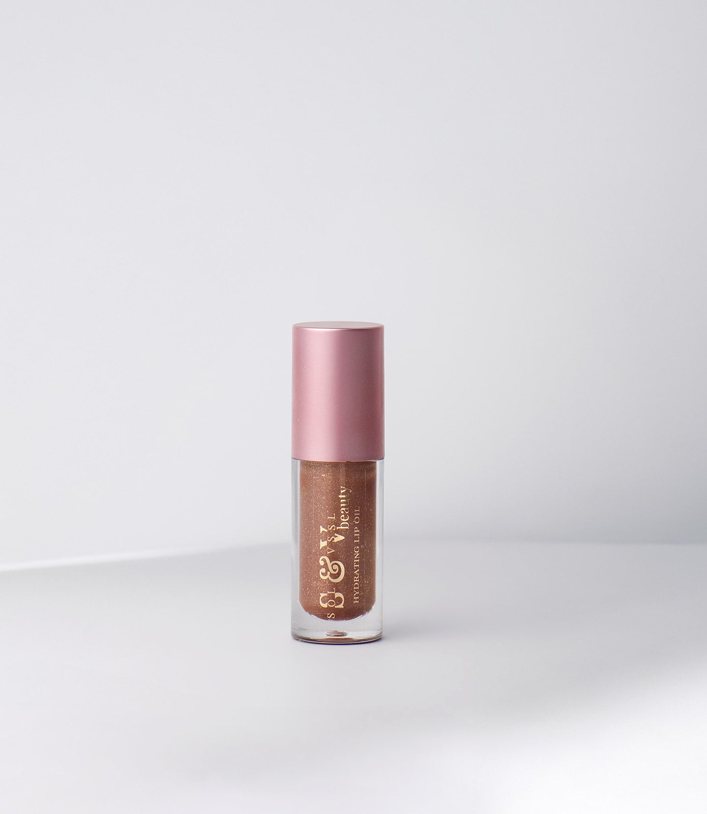 Lip gloss with pink cap on a white background