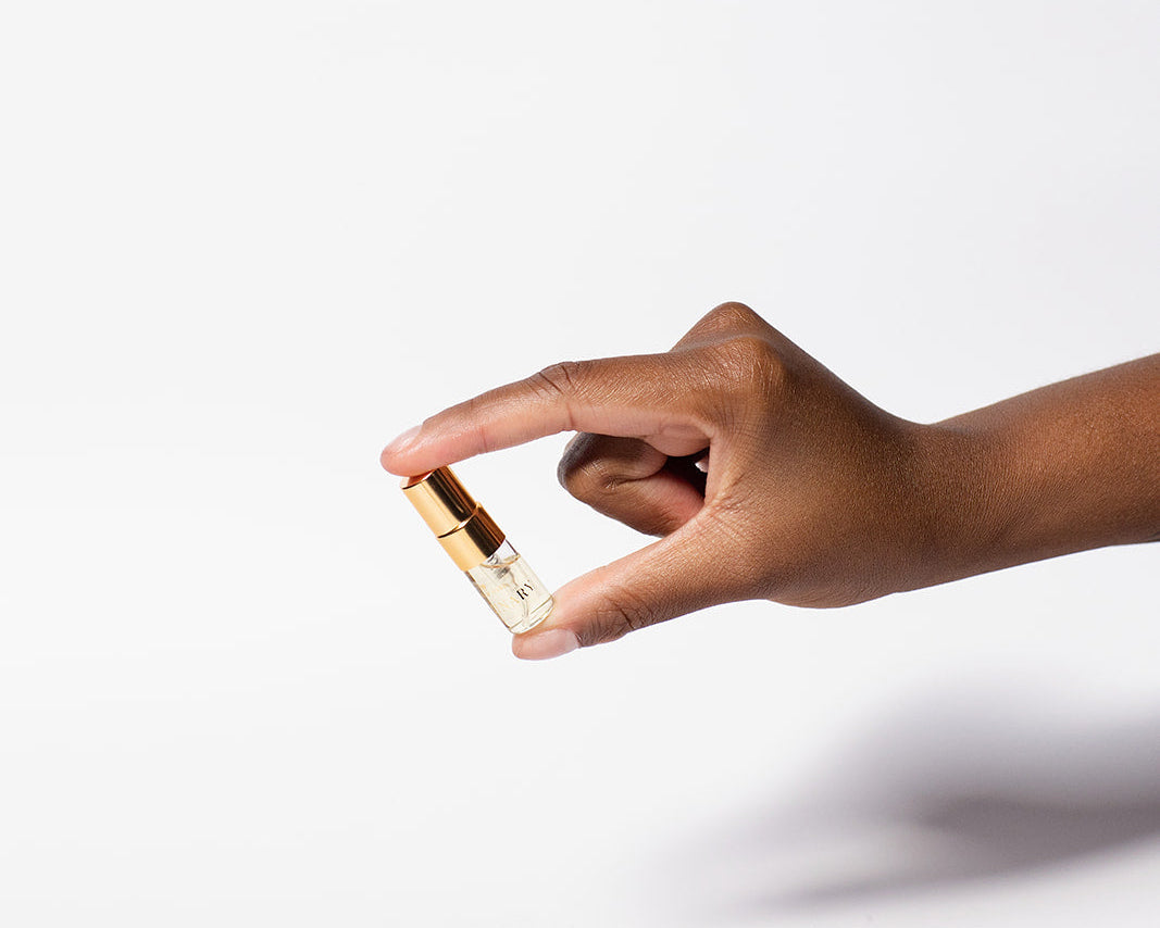Hand holding a small rectangular object against a white background